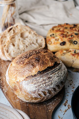 Artisan Batard Sourdough healthy Bread with leaf scoring. Open crumb high hydration Sourdough bread set on white table. - 578353126