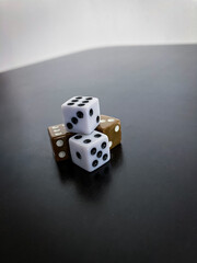 Dice on the table. Cubes on a black background.