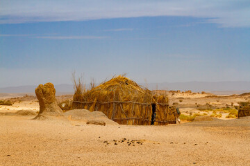 Tuareg encampment in the desert.   Round hut built in a traditional way reed. South of Algeria,...