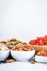 Nuts and dried fruits. Healthy snacks. Dried apricots, figs, raisins, pecans, walnuts, hazelnuts, almonds and other. Gray table background