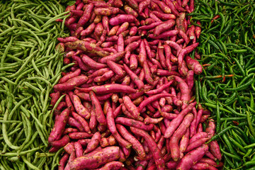 Fresh different vegetables, green bean, yam, sweet potato, pepper on market as background. Top view. Organic texture. Local food and vegetables. Agriculture. Indonesian fresh harvest.