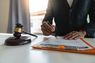 Young Asian lawyer, legal advisor working on financial information Check account documents Detailed legal information before signing the contract Business venture agreement, justice concept.