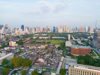 Naklejka premium Aerial view Lumpini central park with modern office building sunset sky downtown