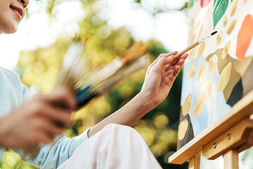 Female artist painting art canvas drawing with inspiration in garden art therapy creativity...