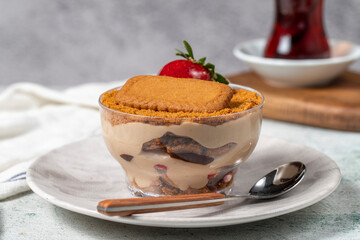 Homemade Strawberry Custard Pudding. Biscuit and strawberry dessert. Turkish magnolia dessert in glass bowl. Close up