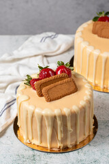 Strawberry, biscuit and white chocolate birthday cake. Chocolate birthday cake with chocolate ganache drip icing