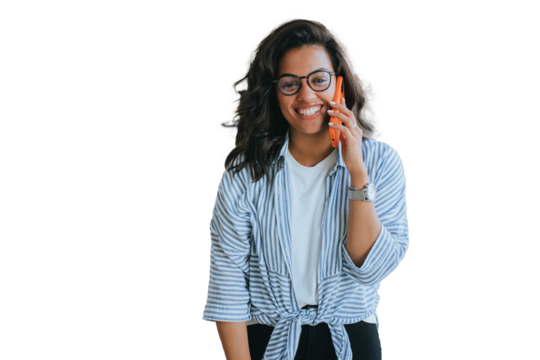 Happy African American girl in glasses, shirt and jeans talks by phone toothy smiles looks at camera excited speaks with boyfriend. Successful young female entrepreneur against transparent  background