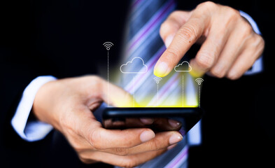 Businessman hand using smartphone with wireless network icon background. Business communication social network concept.