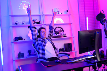 Young Caucasian man Pro Gamer have live streaming  and chatting  with his  fans at home