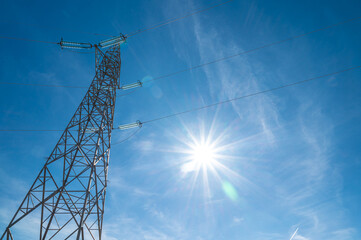 Electricity pylons, in a mountain place. Origin, transport and need for electricity. Environmental...