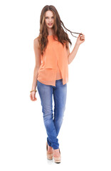 Obraz premium The prettiest woman with an orange fabric shirt and jeans trendy shoes standing with a confident style fashion with hairs isolated on a PNG background