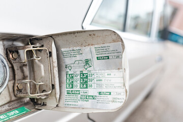 Open gas cap of a white car