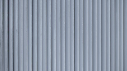 Corrugated sheet metal, badly painted with gray paint for background. Metal corrugated roofing sheet. Abstract background for sites and layouts. Iron fence