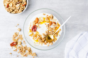 Granola with Nut Mix and Yogurt in a Boal, Healthy Breakfast, Muesli with Nuts and Honey on Bright Background