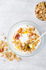 Granola with Nut Mix and Yogurt in a Boal, Healthy Breakfast, Muesli with Nuts and Honey on Bright Background