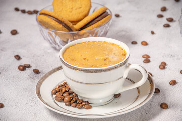 Coffee cup,coffee beans and sweets on the background