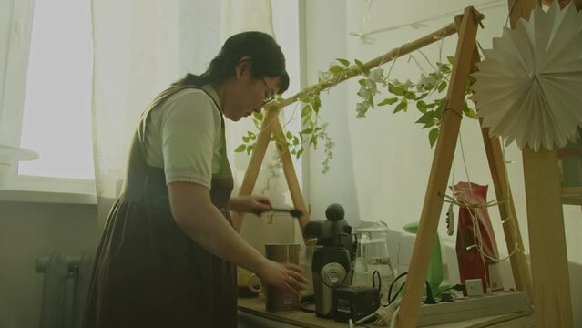 Girl resting in her workshop pottery studio and drink coffee