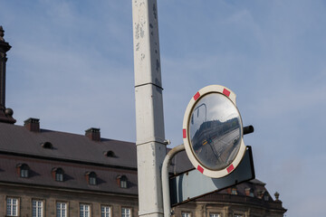 Selective focus view at round traffic mirror which reflected the street view of crossroad and...