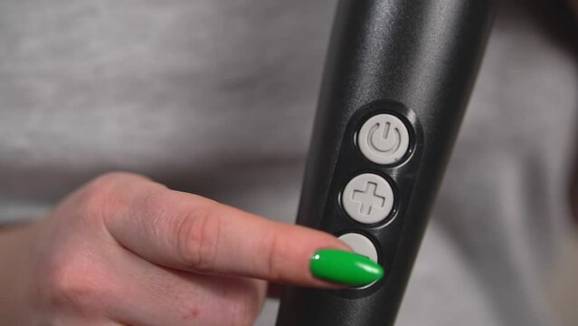 the woman turned on the vibrator. vibrator buttons.close up. slow motion video. High quality Full HD video recording.