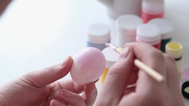 Man painting easter eggs for holiday, hello spring concept, easter preparation concept. Male hands coloring eggs for Easter family holiday