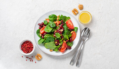 Red Bean Salad On Bright Background, Fresh Salad with Spinach, Cherry Tomatoes, Walnuts, Beans and Mustard Dressing