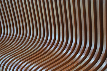 Curved brown wooden slats. Bench element. Abstract background.
