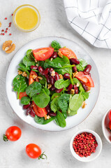 Red Bean Salad On Bright Background, Fresh Salad with Spinach, Cherry Tomatoes, Walnuts, Beans and Mustard Dressing