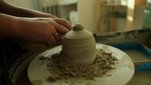Girl works in her atmospheric craft workshop pottery studio