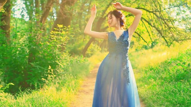 Portrait sexy fantasy woman princess fashion model posing. Beauty face girl evening blue dress. Lady enjoys summer forest green nature tree grass magical sun light. elegant hairstyle. Lady fairy nymph