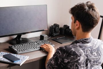 Man working on computer in home office