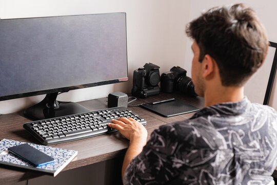 Man working on computer in home office