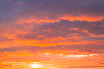 Naklejka na ściany i meble Dark orange sky with clouds at sunset. Natural natural bright background