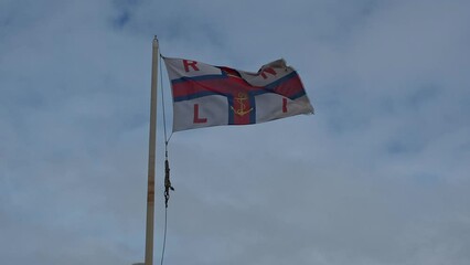 Close and selective focus of an RNLI flag flapping in the breeze