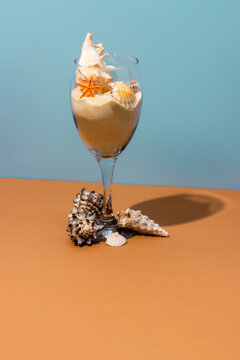 Wineglass with sand and various seashells