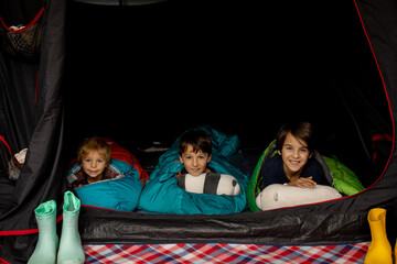 Children, sibilngs, sleeping in sleeping bags in a tent in Norway
