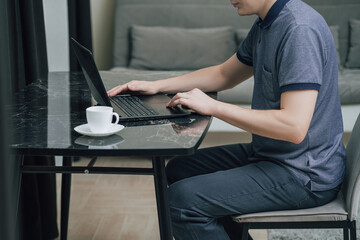 Man working on laptop at home, remote work