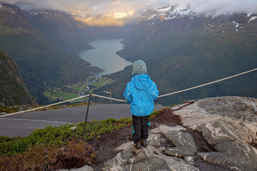 People, adult with kids and pet dog, hiking mount Hoven, enjoying the splendid view over Nordfjord from Loen skylift