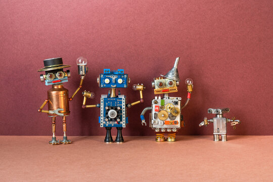 Four toy robots display light bulbs of various shapes and sizes. Machine cyber technology concept