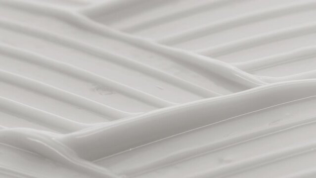 Macro crane shot of white moisturizing cream wave texture | Moisturizing cream background shot for its commercial
