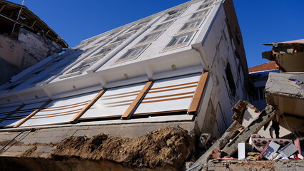 Due to the liquefaction of the ground in the earthquake in Turkey, the building broke from the...
