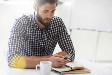 Just another day at the office. a young businessman in his office.