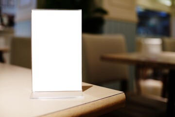 Menu frame standing on wood table in Bar restaurant cafe. space for text marketing promotion.