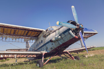 Abandoned old airplane on the field
