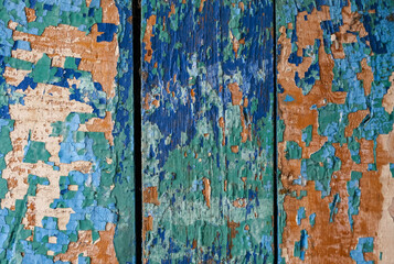 wooden textured surface with chipped colored paint. abstract multicolored background