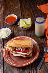 tradicional torta de carne de puerco, con agua fresca de horchata, torta ahogada tipica de guadalajara, jalisco, mejico