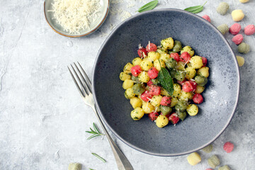 Colorful potato gnocchi on the plate. Vegetarian and vegan food. Top view.