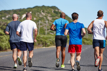 There to motivate each other along the way. Rearview shot of a group of men running a marathon.