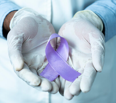 world purple day concept image, Doctor hand with Purple Ribbon Epilepsy Awareness day photo