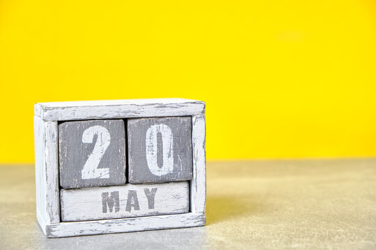 May 20 calendar made wooden cubes yellow background.With an empty space for your text.