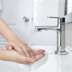 Men are washing their hands in the sinks to clear respiratory bacteria and viruses, sanitation and...